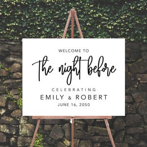 May include: White sign with black text on an easel. The sign reads "Welcome to The night before Celebrating Emily & Robert June 16, 2050".