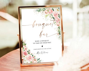May include: A white sign with a floral border and gold lettering that reads "bouquet bar". The sign also includes the text "Make a bouquet to take on your way!" and "Compliments of the future Mrs. Williams."