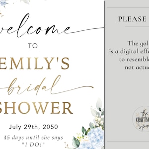 May include: A bridal shower sign with the text "welcome to Emily's bridal shower" in gold and black script. The date is July 29th, 2050, with a note about the gold foil effect. Floral accents in blue and green.