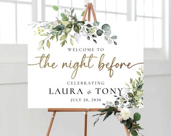 May include: White welcome sign with green foliage and gold lettering. The sign reads "Welcome to the night before celebrating Laura & Tony July 20, 2030".