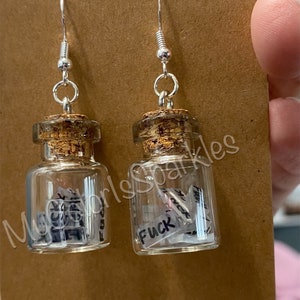 Jar of mini “Fu*ks” earrings