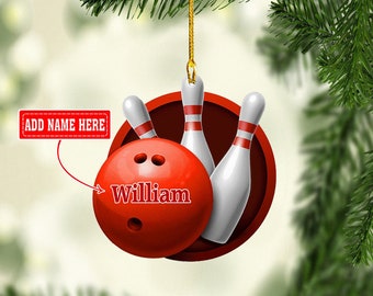 May include: Red and white bowling ball Christmas ornament with three white bowling pins. The bowling ball has the name "William" written on it.