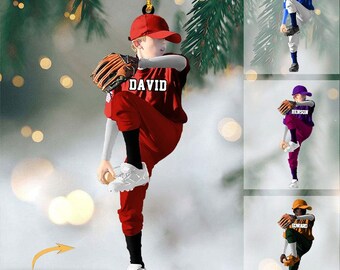 May include: Personalized baseball ornament featuring a child in a red, white, and blue uniform, pitching a baseball. The ornament is decorated with the name "DAVID" and the text "NAME CAN BE CHANGED".