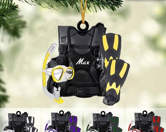 May include: A black scuba diving gear ornament with yellow fins, a yellow snorkel, and a yellow diving mask. The ornament has the name "Max" written on it.