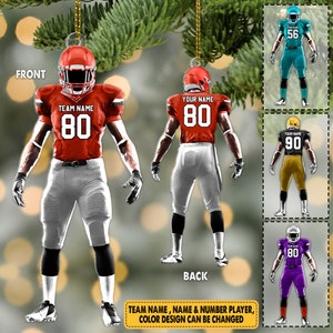 May include: A red, white, and black football player ornament with the text "TEAM NAME" and the number "80". The ornament is shown from the front and back. The text "YOUR NAME" and the number "80" are also shown on the ornament. The text "TEAM NAME, NAME & NUMBER PLAYER, COLOR DESIGN CAN BE CHANGED" is shown at the bottom of the image.