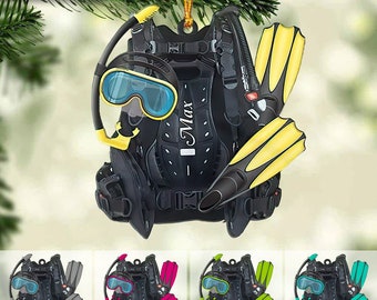 May include: A black scuba diving ornament with yellow fins, a black scuba mask, and a yellow snorkel. The ornament has the name "Max" written on it.