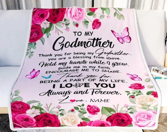 May include: Pink and white floral throw blanket with a message to a godmother. The text reads "To my Godmother. Thank you for being my Godmother. You are a blessing from above. Hold my hands while I grow. Guide me in my faith. Encourage me to share. Thank you for being a part of my life. I love you. Always and Forever. Love. NAME"