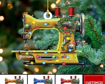 Puede incluir: Adorno navideño de máquina de coser amarilla con una corona y luces de cadena. El adorno tiene el texto "Your name" en la parte delantera. Se muestran opciones de color adicionales: naranja, azul y rojo.