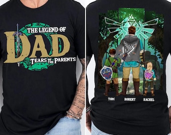 May include: Black t-shirt featuring the text "THE LEGEND OF DAD TEARS OF THE PARENTS" in green and gold. The back of the shirt shows a family of three in a forest setting, with the names Tom, Robert, and Rachel below the figures.
