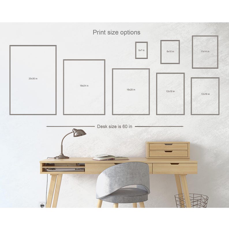 May include: A white wall with a desk and chair in front of it. The wall has a grid of different sized frames with the text "Print size options" and the dimensions of each frame in inches. The text "Desk size is 60 in" is below the frames.
