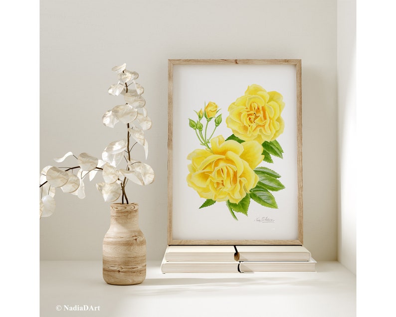 May include: A watercolor painting of yellow roses with green leaves. The painting is framed and displayed on a shelf with books.