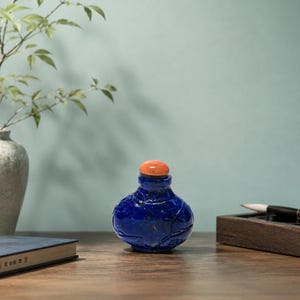 Blue Lapis Style Chinese Snuff Bottle with Carved Fish Motif and Coral Color Stopper