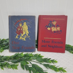May include: Two vintage children's books with colorful covers. The book on the left has a blue cover with a picture of two children walking a dog in the rain. The book on the right has a red cover with a picture of three children on a sled. The book on the left says "Our New Friends" and the book on the right says "More Friends and Neighbors".