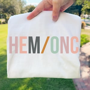 May include: A set of three ceramic mugs with a speckled, matte finish. The mugs are in shades of cream, light gray, and dark gray. Each mug has a simple, minimalist design, perfect for coffee or tea.