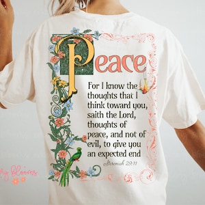 May include: A white t-shirt with a floral design and the text "Peace" in a vintage font. The text is surrounded by a floral border and includes the Bible verse Jeremiah 29:11, which reads "For I know the thoughts that I think toward you, saith the Lord, thoughts of peace, and not of evil, to give you an expected end."