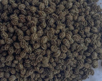 May include: A close-up image of a pile of dried black seeds. The seeds are small and round, with a slightly wrinkled texture.