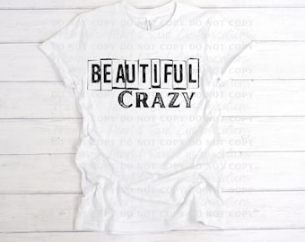 May include: White t-shirt with black text that reads "BEAUTIFUL CRAZY" in a blocky font.