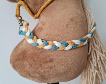 May include: A brown plush horse head with a white, yellow, and blue braided rope halter.