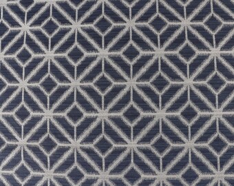 May include: A navy blue fabric with a white geometric pattern. The pattern is made up of repeating diamonds and squares.