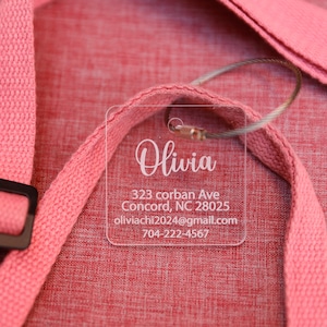May include: A clear plastic luggage tag with the name Olivia, address 323 corban Ave, Concord, NC 28025, email oliviacchi2024@gmail.com, and phone number 704-222-4567.