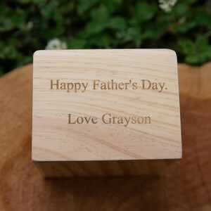 May include: A wooden block with the text "Happy Father's Day. Love Grayson" engraved on it.