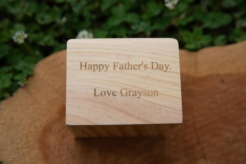 May include: A wooden block with the text "Happy Father's Day. Love Grayson" engraved on it.