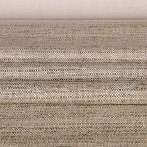 May include: Close-up of folded fabric with a textured weave. The fabric has a neutral color palette of beige and gray, with subtle variations in tone. The material appears to be linen or a similar natural fiber, suitable for upholstery or drapery.