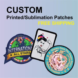 May include: A collection of custom printed patches. One patch features a woman flexing her arm with the word "Pride". Another patch has an owl design with the words "Visions From The Dream Diary" and "Fellow Dreamer". The third patch says "International All Stars".
