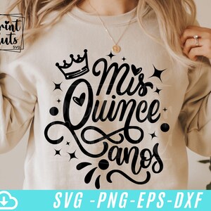 May include: A white sweatshirt with a black design that says "Mis Quince Anos" with a crown and a heart.