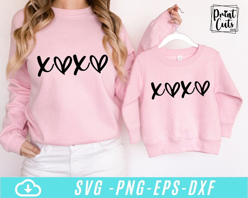 May include: Two pink sweatshirts with the text "X♡X♡" printed in black. The sweatshirts are shown on a white background.