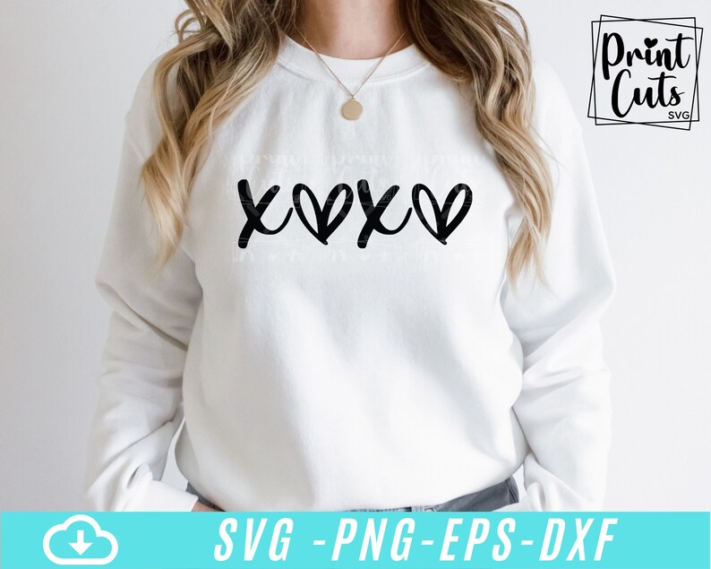May include: White sweatshirt with a black graphic design that says "XOXO" with hearts replacing the "O"s.