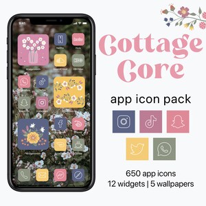 May include: A phone screen mockup with a cottagecore aesthetic. The phone screen displays a variety of app icons with floral and nature-inspired designs. The text "Cottage Core" is displayed in pink letters above the phone screen. The text "app icon pack" is displayed below the phone screen. The text "650 app icons 12 widgets | 5 wallpapers" is displayed below the app icon pack text.
