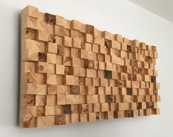 May include: A wall-mounted sound-absorbing panel made of wooden blocks in various sizes and shades of brown. The blocks are arranged in a random pattern, creating a unique and modern design.