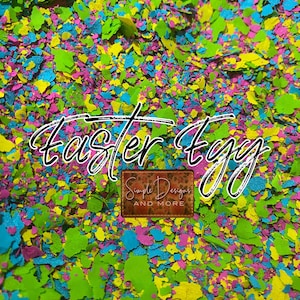 May include: A close-up of colorful confetti in shades of green, yellow, blue, and pink. The confetti is scattered across the surface and reads "Easter Egg" in black cursive writing. A small white label with the text "Simple Designs and More" is visible in the lower center of the image.