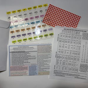 May include: A set of 2027 ASA FAR AIM template and POH tabs, including a white envelope, a sheet of red circular stickers, a multi-colored sticker sheet with text, a flight training poster with text, and two pens, one blue and one yellow.