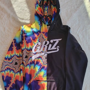 May include: A black and multi-coloured hoodie with a psychedelic pattern on one side and a black side with the word "GRIZ" in white lettering.
