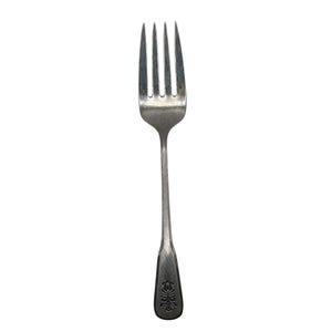 May include: A silver fork with four tines, a long handle, and a decorative floral design at the base. The fork is made of metal and is set against a white background. This utensil is suitable for dining.
