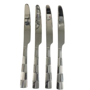 May include: Four stainless steel dinner knives. The blades are smooth and the handles have a geometric, checkered design. The knives are arranged vertically against a white background.