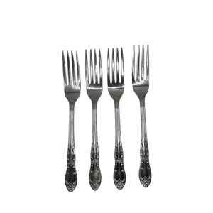 May include: Four silver forks with ornate floral detailing on the handles. The tines are evenly spaced, and the forks are arranged against a white background. These forks are suitable for formal dining.