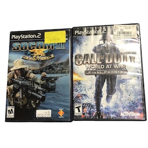 May include: Two PlayStation 2 video game cases. The first is "SOCOM III U.S. Navy Seals" with soldiers in combat. The second is "Call of Duty World at War Final Fronts" with a soldier in silhouette. Both cases have price stickers.