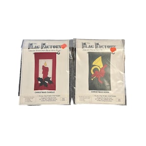 May include: Two packaged Christmas flag patterns from The Flag Factory. One features a red candle with holly, the other a gold horn with a red bow. Both are designed for flags that finish 28" x 40" and include sewing instructions.
