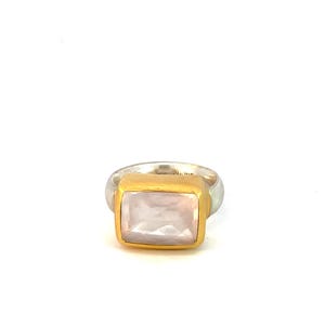 May include: A silver ring with a gold setting and a rectangular white gemstone.