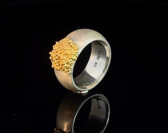 Elegant sterling silver ring with gold-plated accents