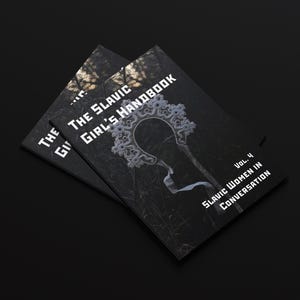 May include: Two copies of "The Slavic Girl's Handbook" are stacked on a black surface. The book cover is dark with white text and a decorative illustration. The text reads "Slavic Women in Conversation."