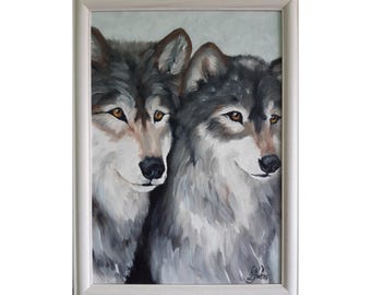 May include: A framed oil painting depicting two wolves with grey, white, and black fur and amber eyes. The wolves are positioned side by side, facing forward with a soft expression. The artwork is enclosed in a simple, light-colored frame.