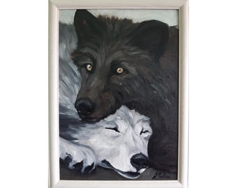May include: An oil painting in a white frame depicting two wolves. A dark brown wolf with amber eyes rests its head on a white wolf that has its eyes closed. The painting features visible brushstrokes and a signature in the bottom right corner.