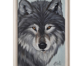 May include: A framed painting of a wolf's head with a light blue background. The wolf has a gray and white coat with piercing yellow eyes. The painting is signed "Gil Juno".