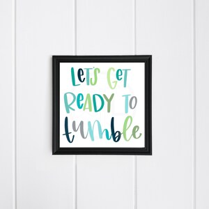 May include: A framed print with the text "Let's Get Ready To Tumble" in colorful, handwritten lettering. The background is white.