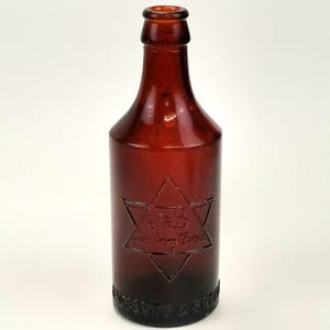 Antique Amber Glass Bottle: Jewsbury & Brown Manchester, c.1900s
