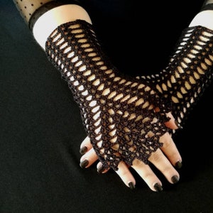 May include: A pair of black crocheted fingerless gloves with a delicate openwork pattern.